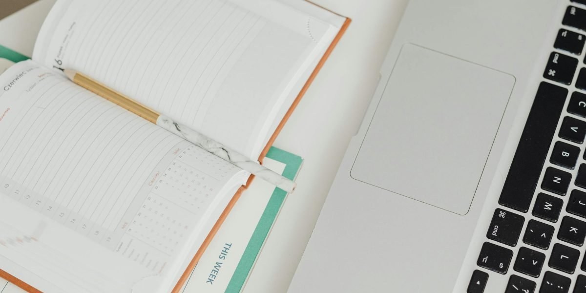 Open laptop with mental health reference materials on a desk