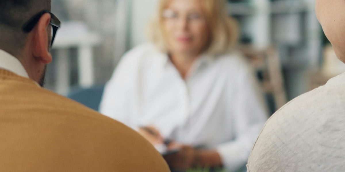 Individuals consulting with a mental health professional in a supportive environment.