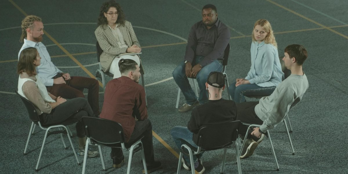 A group of people engaged in learning or discussing, symbolizing the power of education and support in mental health.