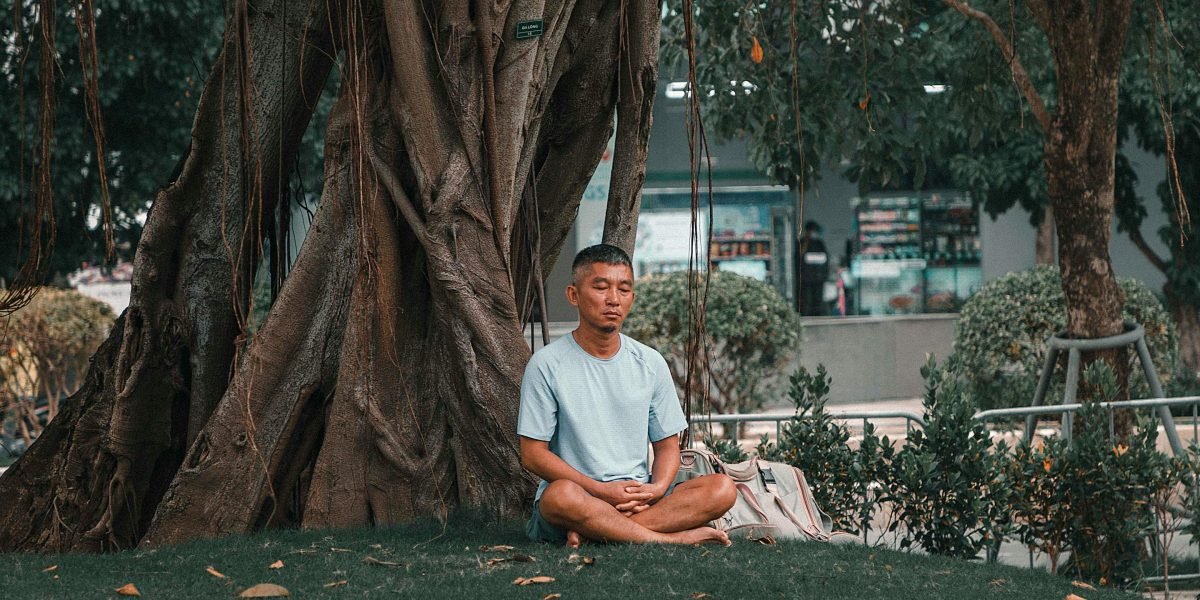 An individual engaging in a grounding exercise, focusing on their senses or body to reconnect with the present moment.