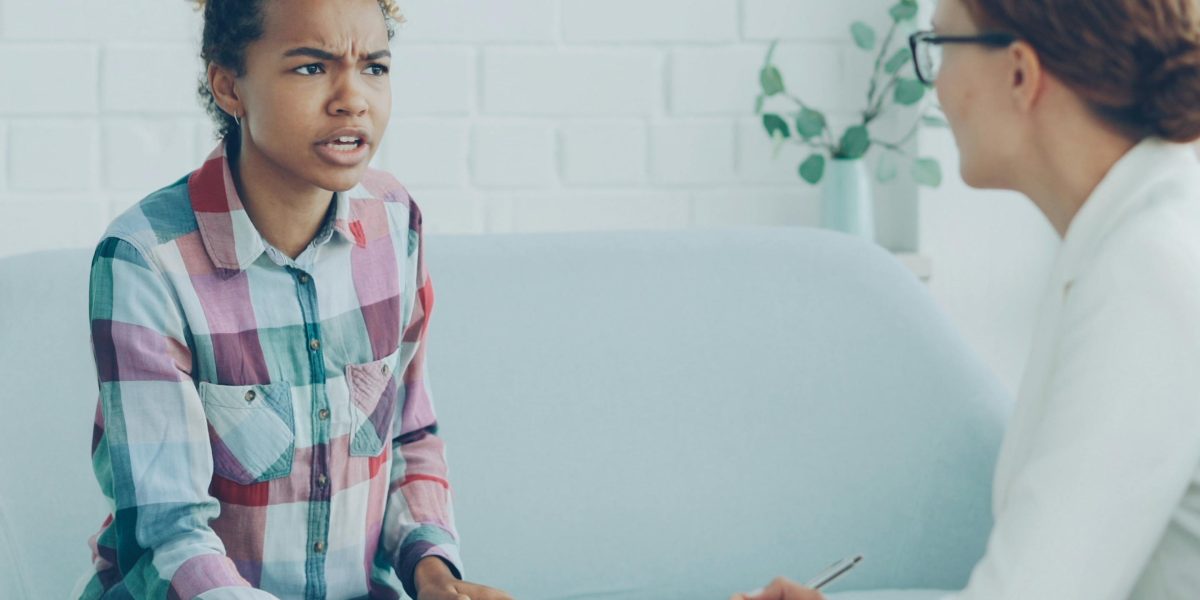 An individual engaging in a supportive conversation with a mental health professional.