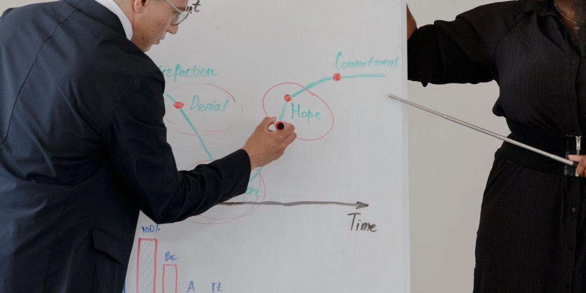 A mentor guiding a younger professional, emphasizing continuous learning and development in their field.