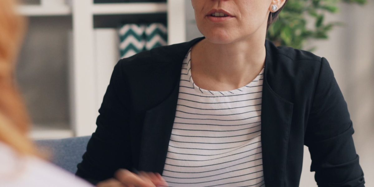 Seeking professional guidance by speaking with a therapist or counselor in a calm environment.