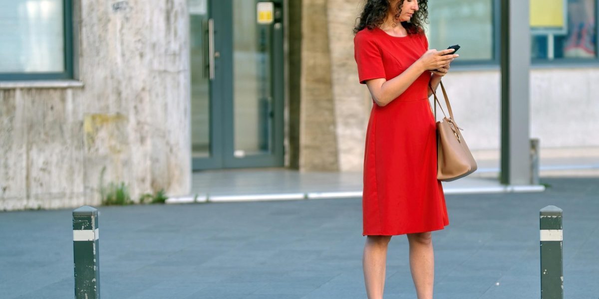 A person scrolling through their phone, looking thoughtful or validated by something they see.