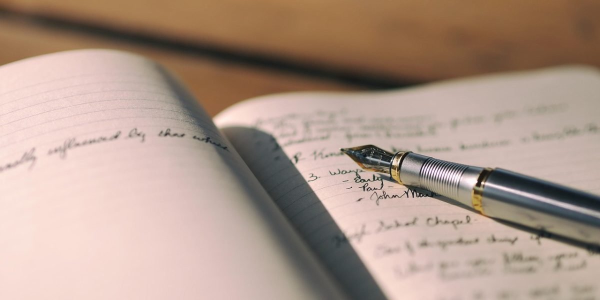 A person writing in a journal, representing self-monitoring and tracking mood changes.
