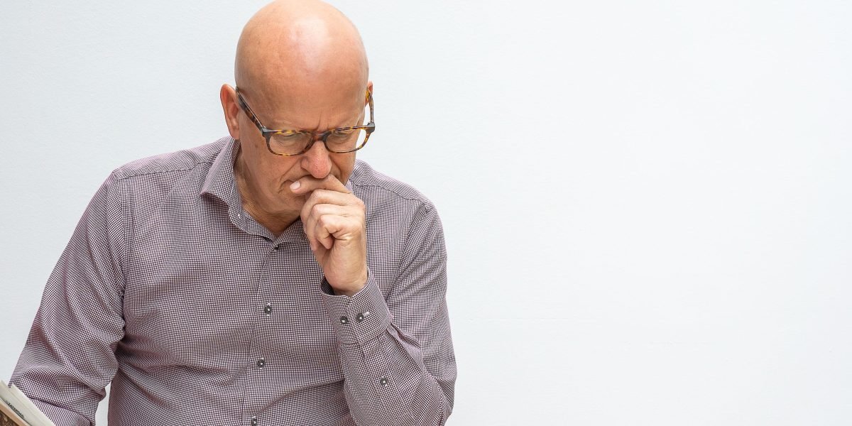 A person thoughtfully searching for reliable mental health information online, symbolizing the challenge of finding trustworthy resources.