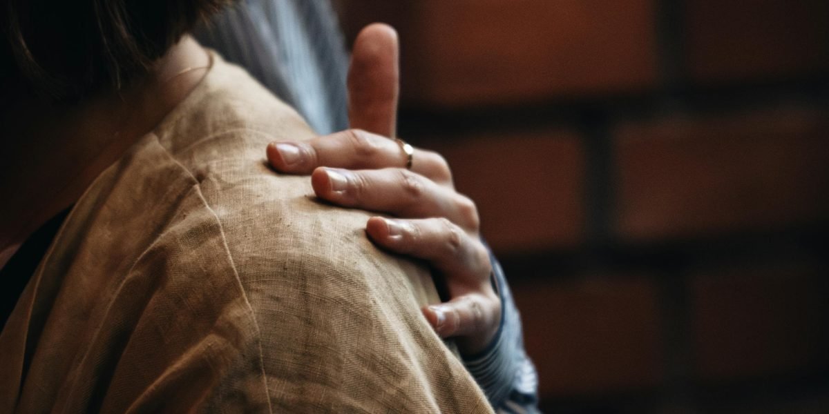 A compassionate interaction between a person in distress and a supportive individual, representing urgent mental health help.