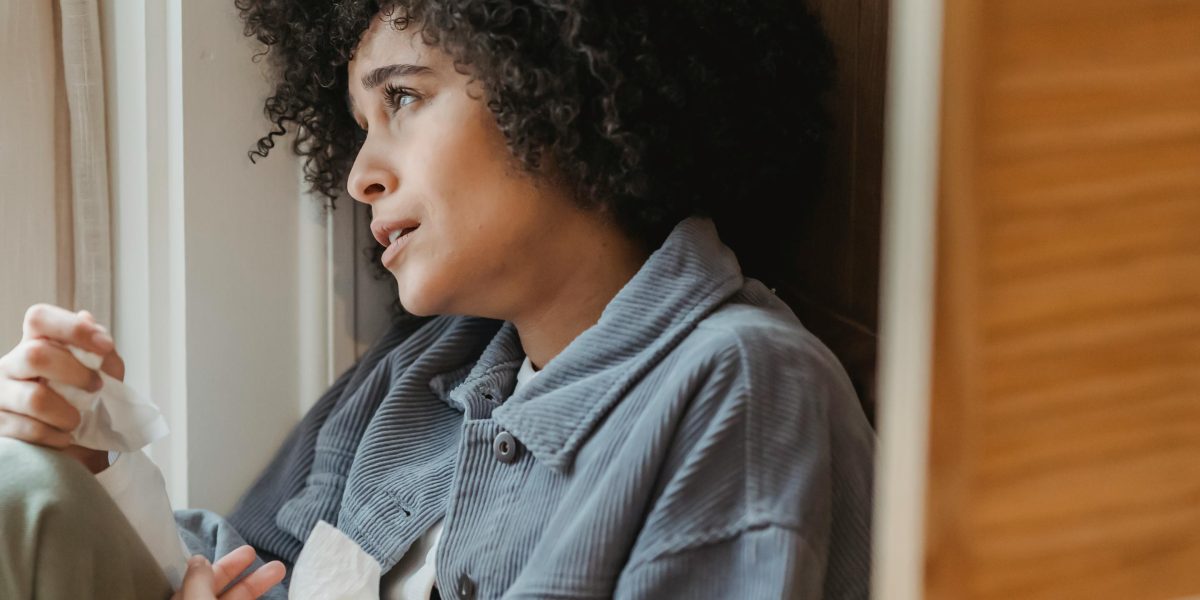 A person looking thoughtful and somewhat disengaged, reflecting feelings of detachment or unreality.