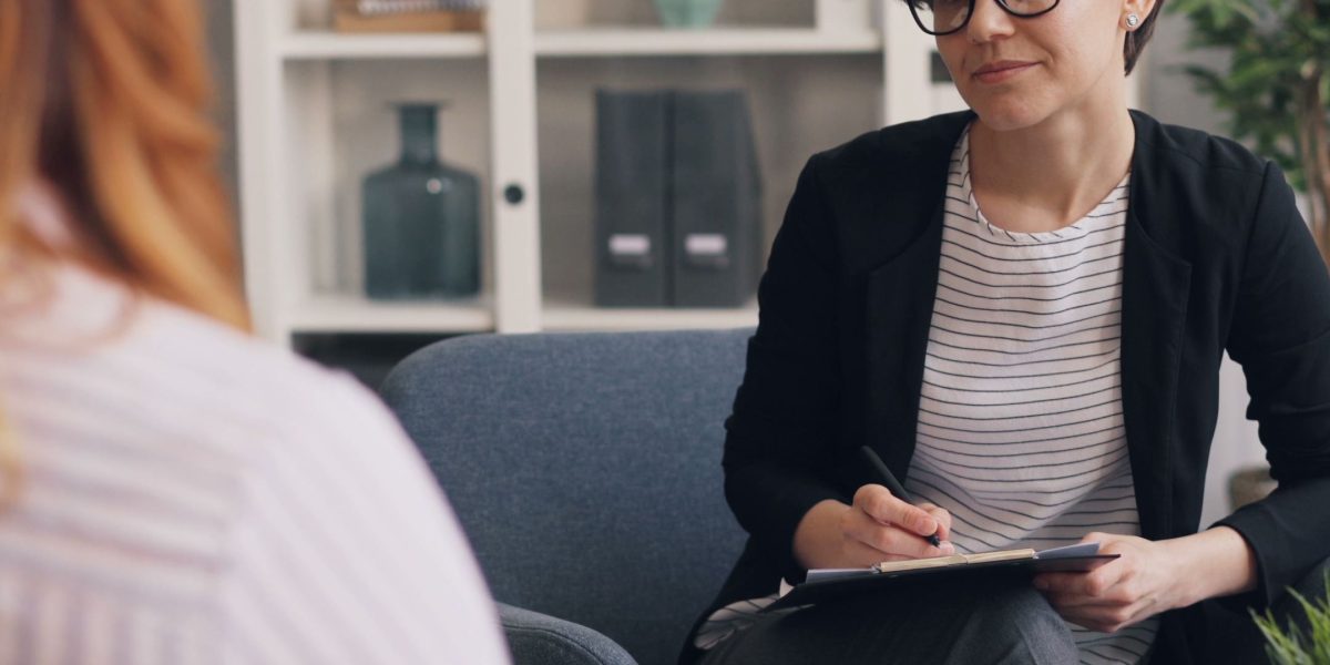 A professional and a client engaged in a counseling session, representing the diagnostic and assessment process.