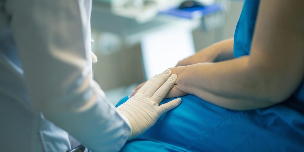 A doctor attentively listening to a patient, emphasizing the critical role of open and empathetic communication in the diagnostic process.