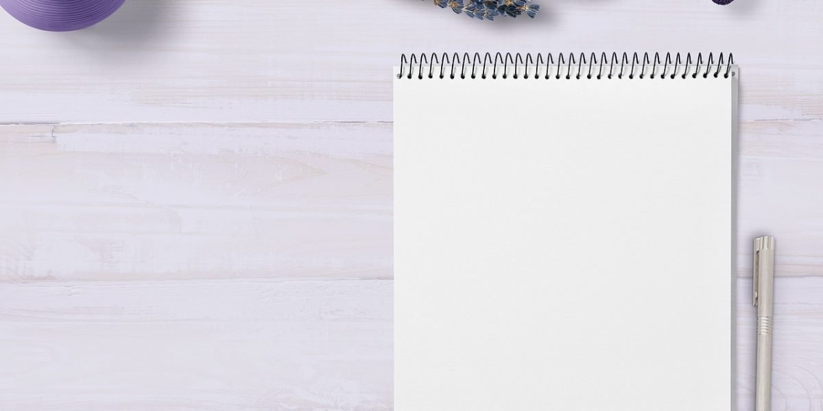 A caregiver thoughtfully taking notes, preparing to communicate effectively with healthcare providers.