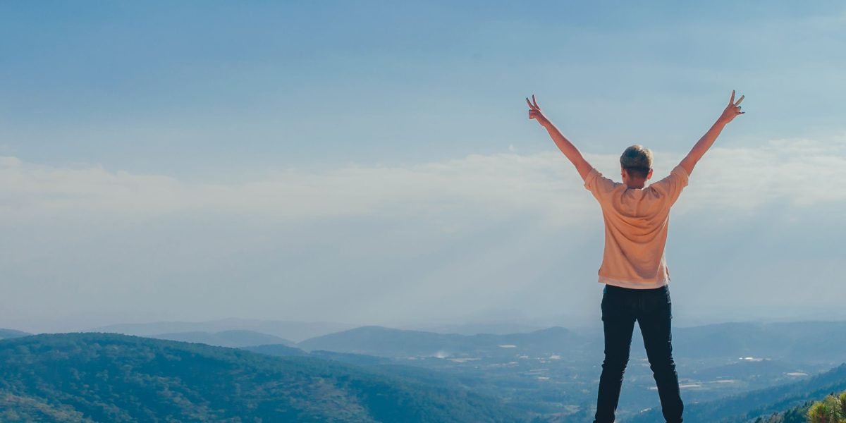 A person looking triumphant, symbolizing the process of overcoming fears and challenges in therapy.