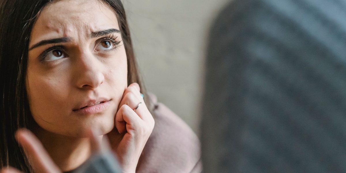 A therapist demonstrates cultural humility by actively listening and asking clarifying questions to understand their client's unique background.