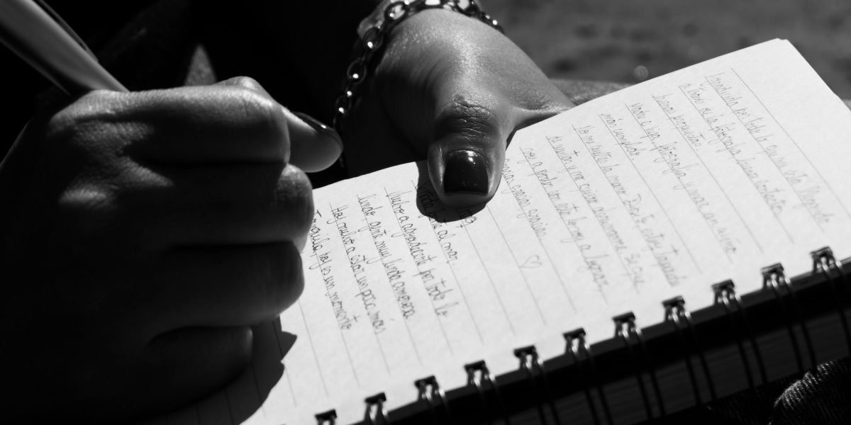 A person journaling, a powerful tool for self-assessment and recognizing patterns of emotional abuse.