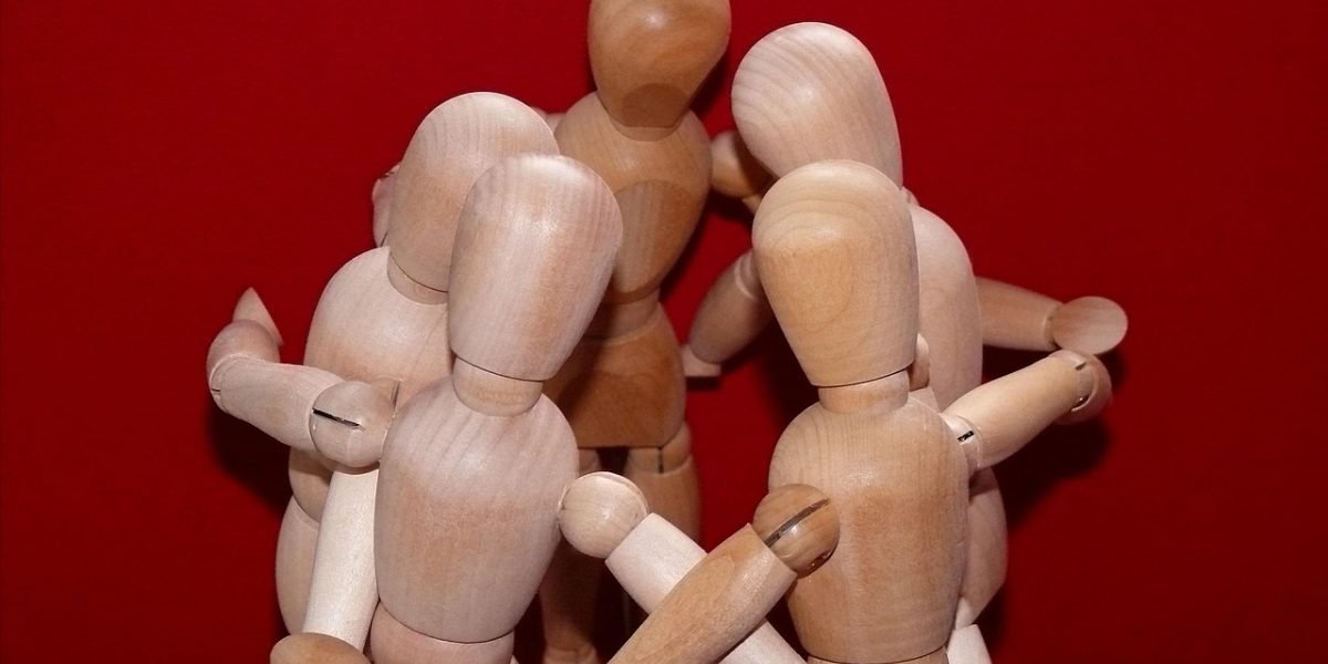A group of people actively collaborating and brainstorming ideas, representing the partnership in postmodern therapy approaches.