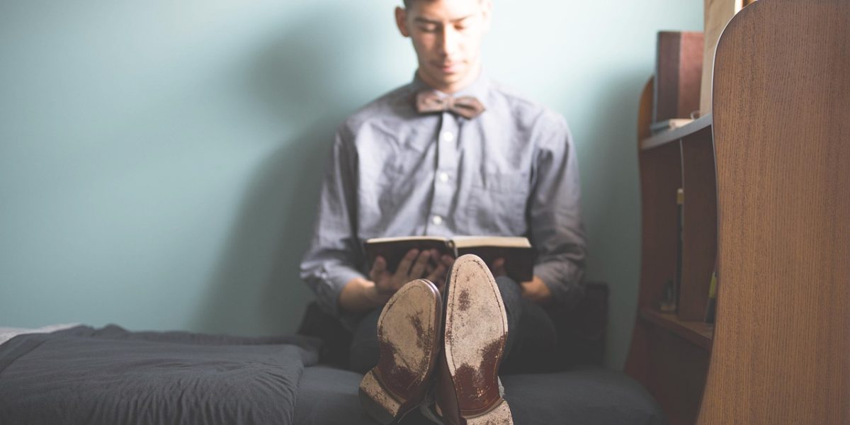 A person engaged in thoughtful reading, seeking deeper understanding of complex topics like mental health.