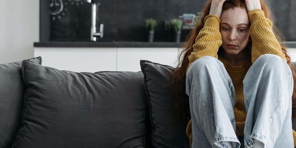 A person sitting alone, reflecting on feelings of deep sadness or emotional burden.