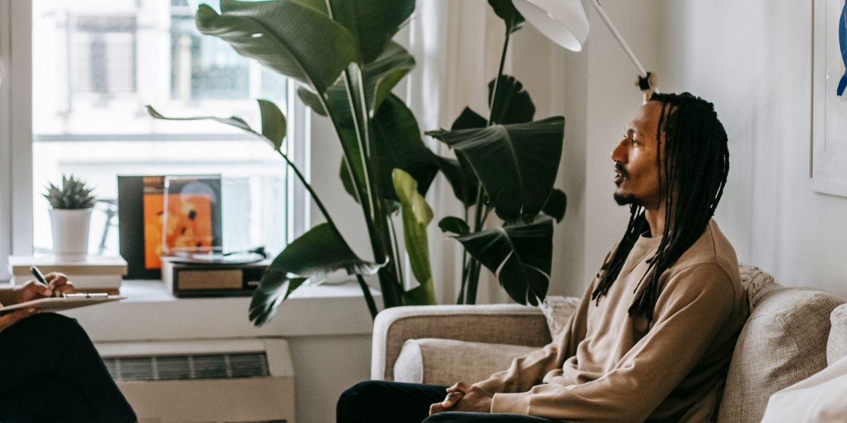 A therapist and client engaged in a serious and supportive conversation, representing professional understanding.