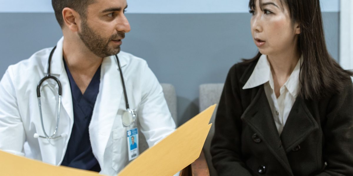 A healthcare professional engages in an empathetic conversation with a patient, reflecting a diagnostic interview.