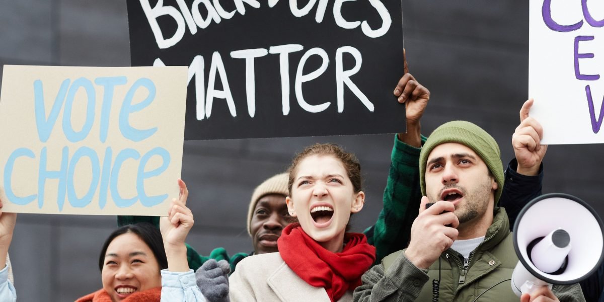 A diverse group of community members engage in a meeting, passionately advocating for their collective rights and needs.