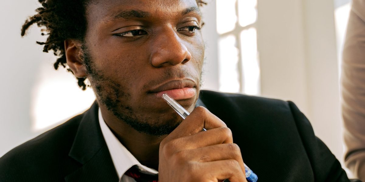A person thoughtfully considering options for mental health support, reflecting the decision-making process.